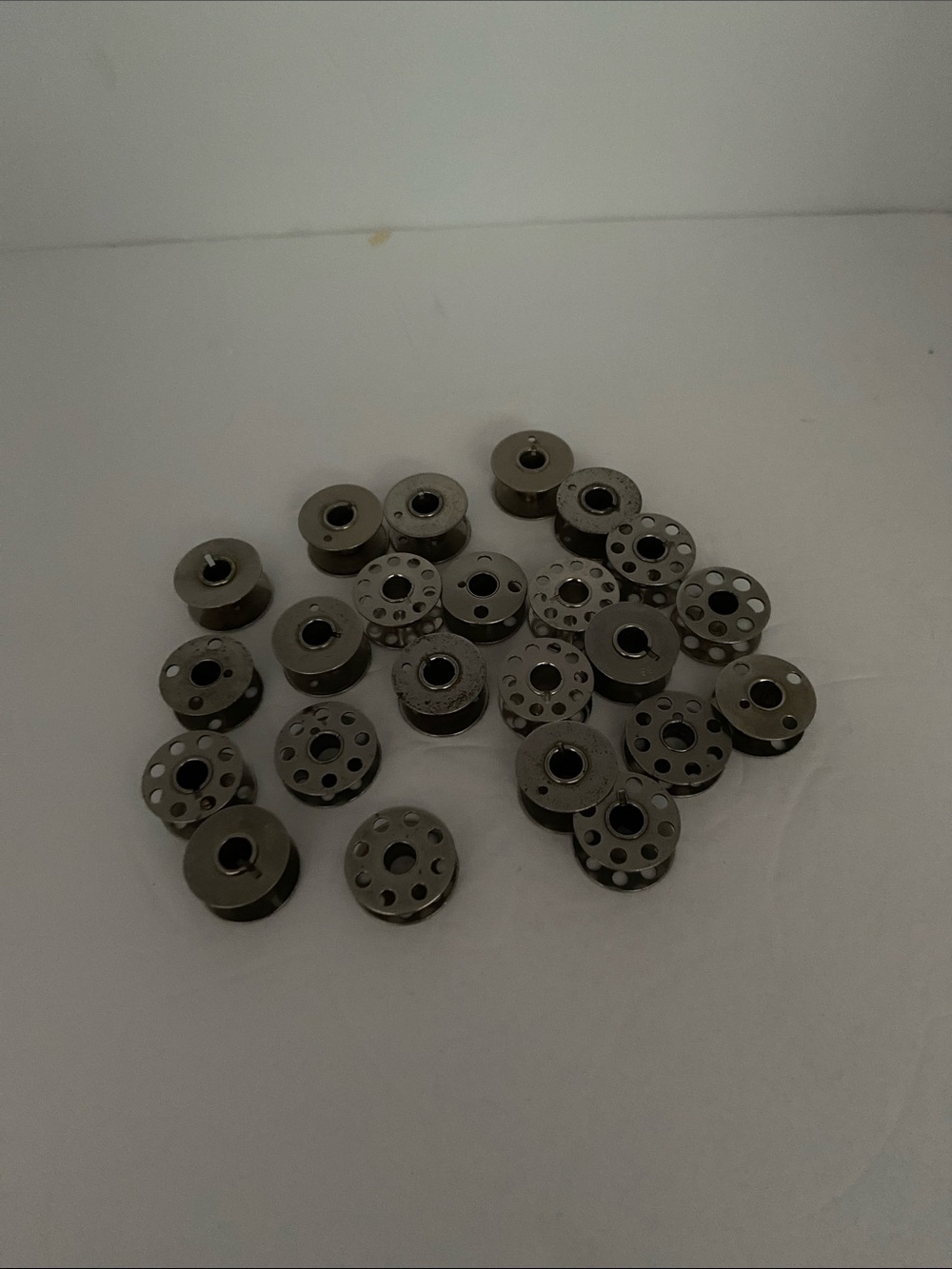 23 Assorted Metal Sewing Machine Bobbins - Silver
